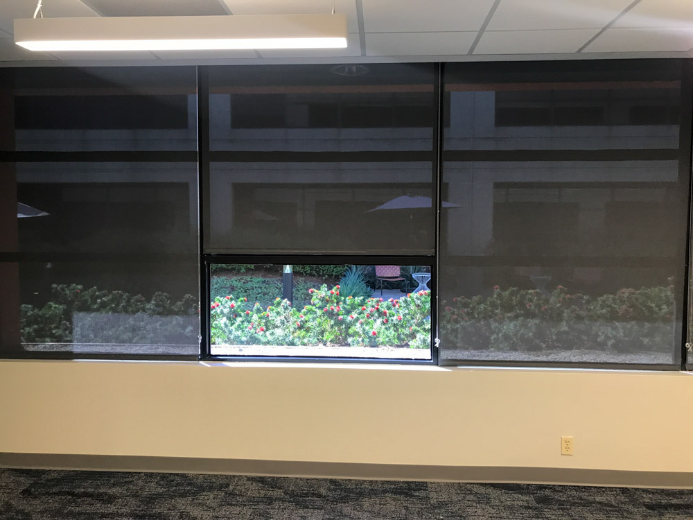 Office window shade installed for sunlight light protection and energy efficiency purposes