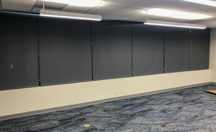 Several sets of window shades installed in an office