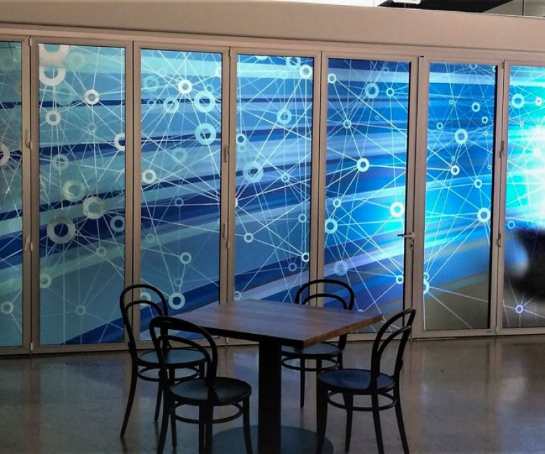 In a commercial space, windows are covered with artistic details