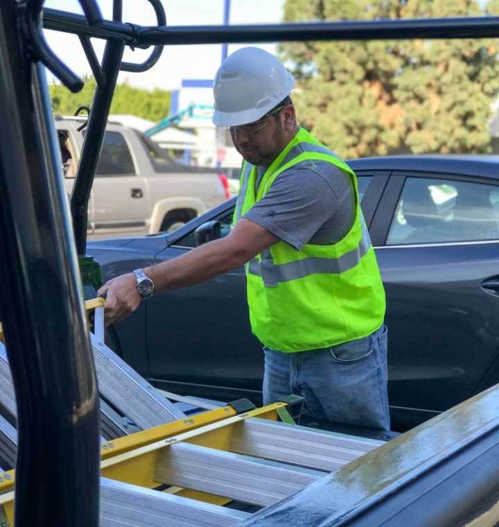 A skilled window treatment expert fixing materials used in installing window coverings in the utility vehicle